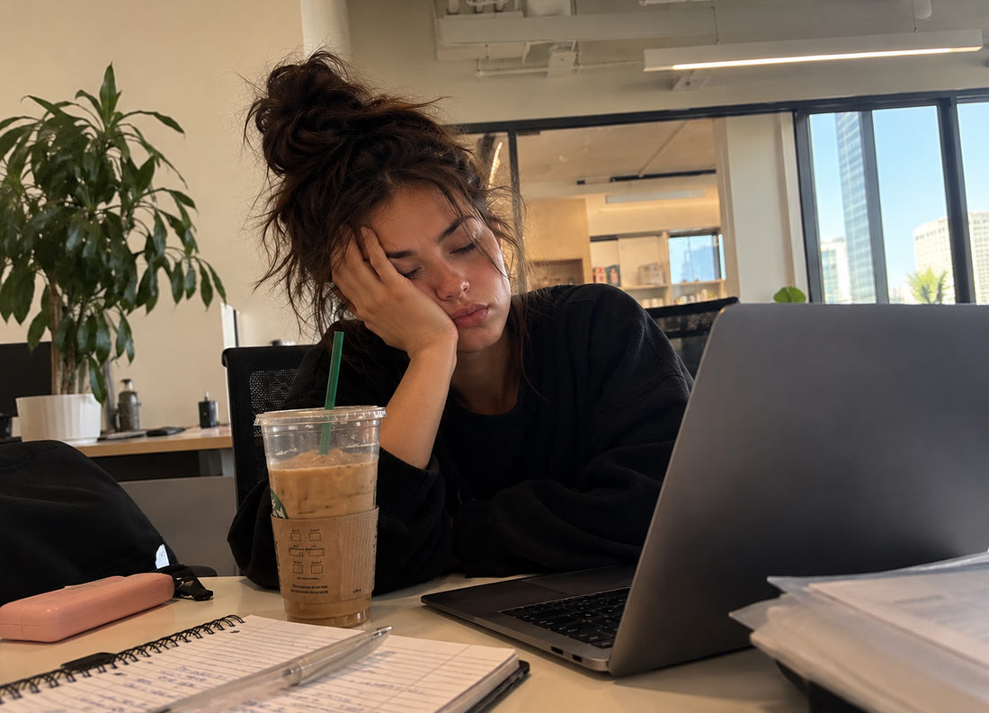 Woman resting her head on her hand at a desk